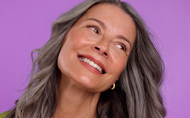 Woman smiling with her head tilted