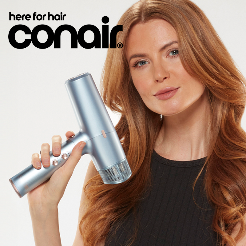 Woman holding hair dryer