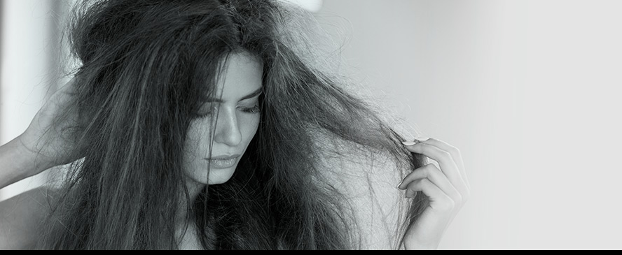 Woman with tangled, frizzy hair.